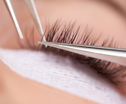 macro shot of application of false eyelashes
